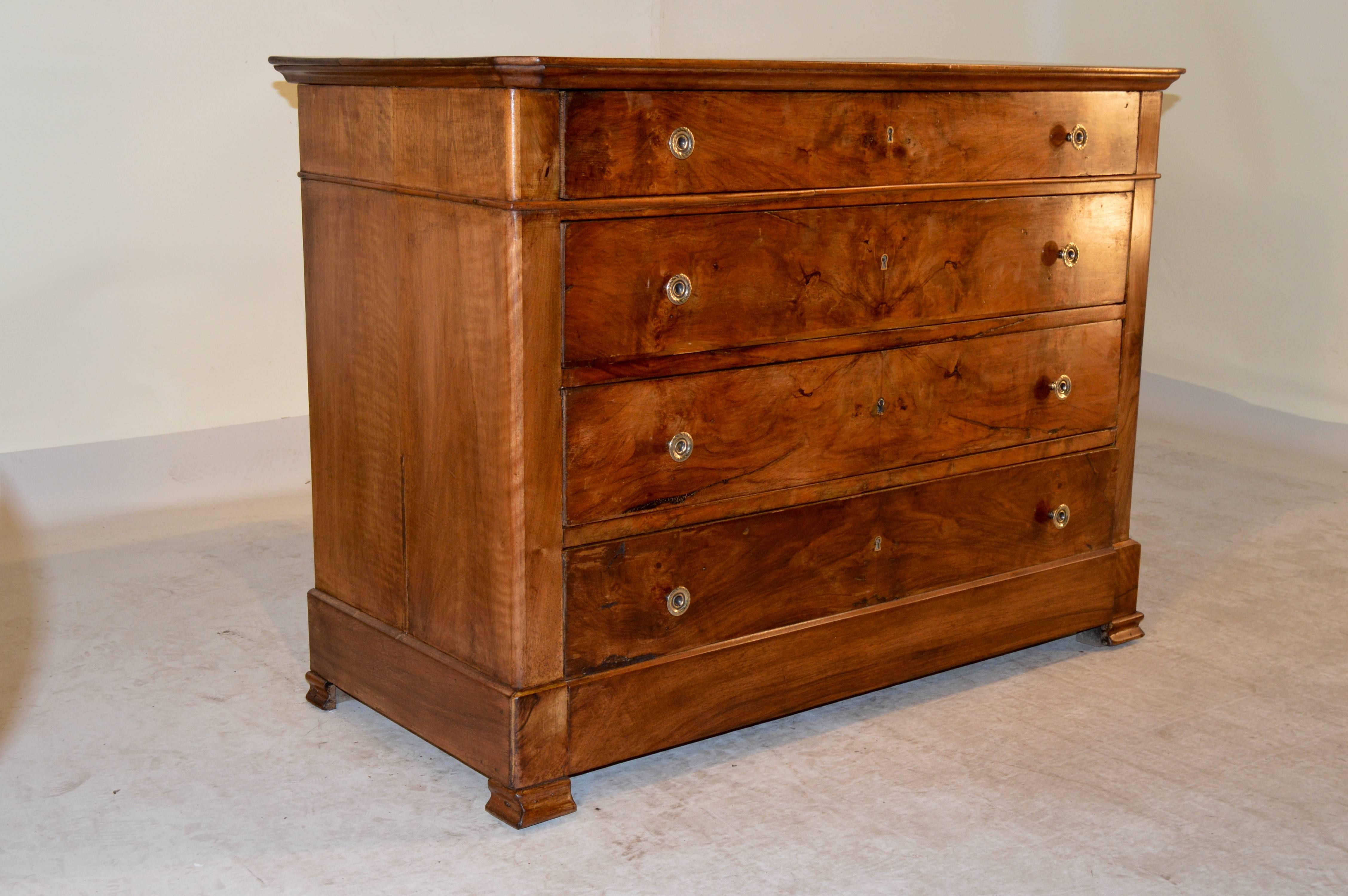 19th Century French commode in the Louis Phillipe manner.  The top has slight shrinkage.  The case contains four drawers with burl walnut drawer fronts over a banded base and blocked molded feet.  