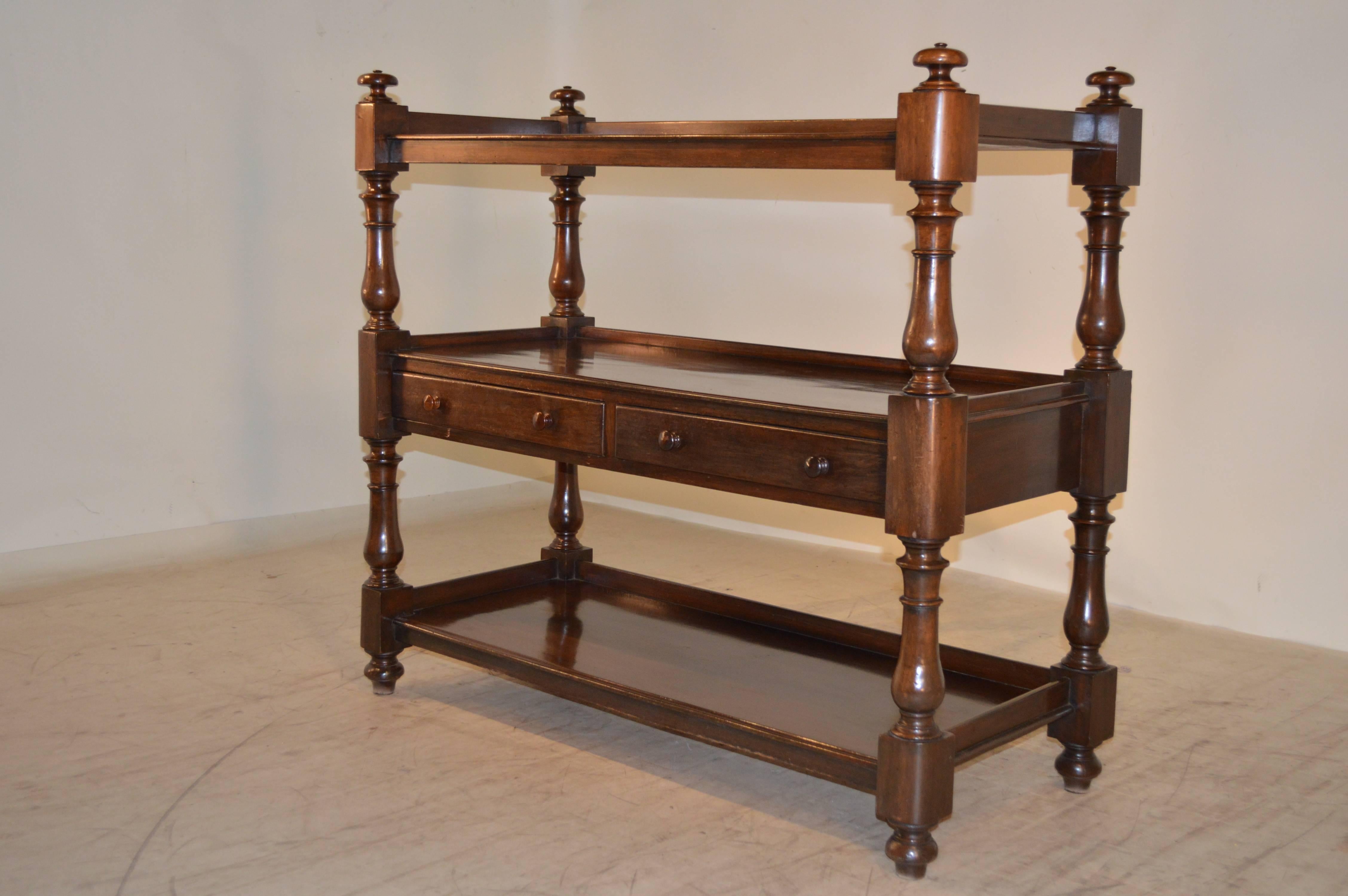 19th century English mahogany buffet with three shelves. The shelves have galleries and are supported on wonderfully turned legs and shelf supports. Age wear, staining on shelves.
