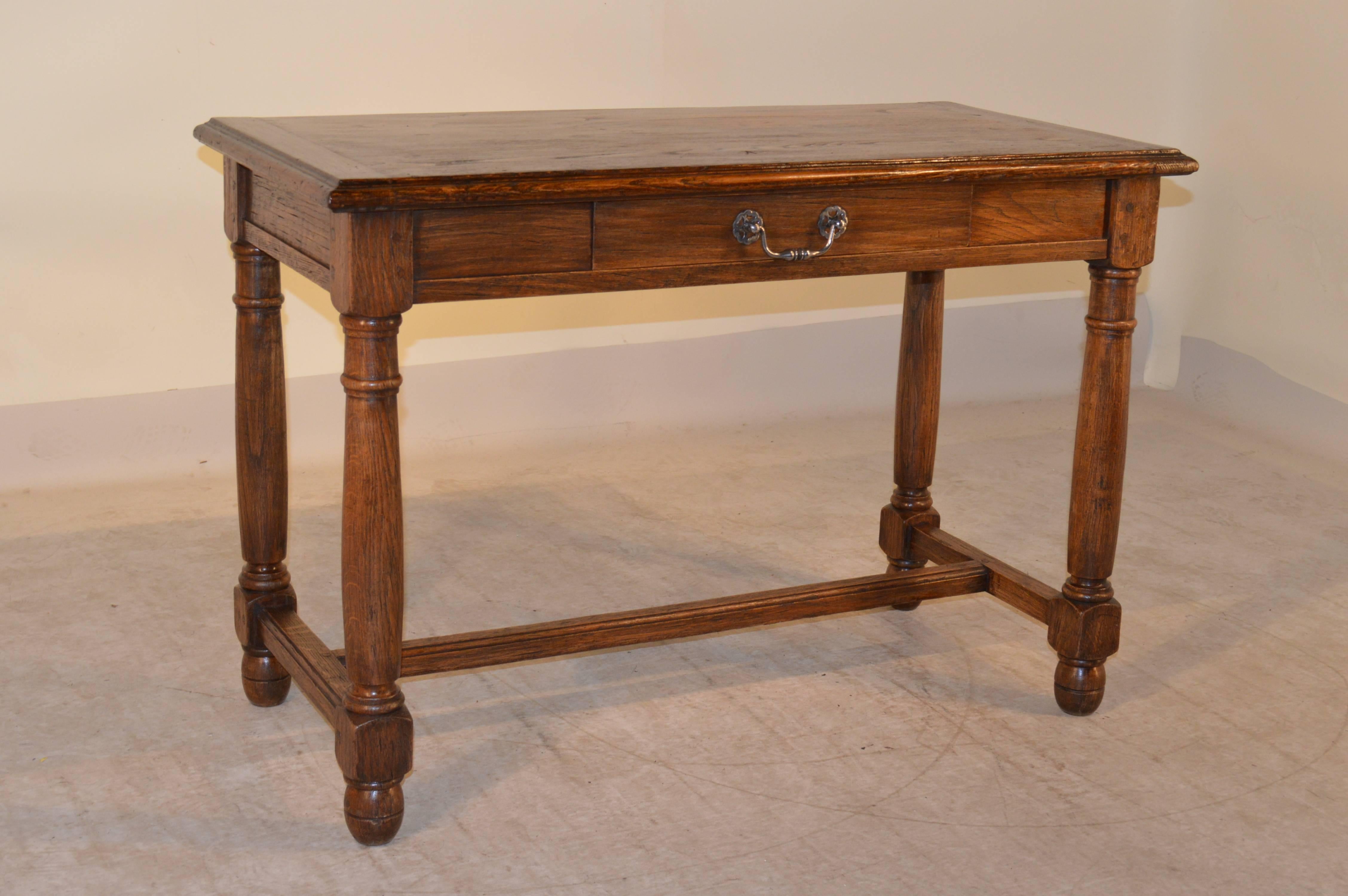 19th century French oak console table with banded ends on the top, which is also bevelled around the edge. There is a single drawer in the front, and it is supported on hand-turned legs and feet, joined by simple stretchers.