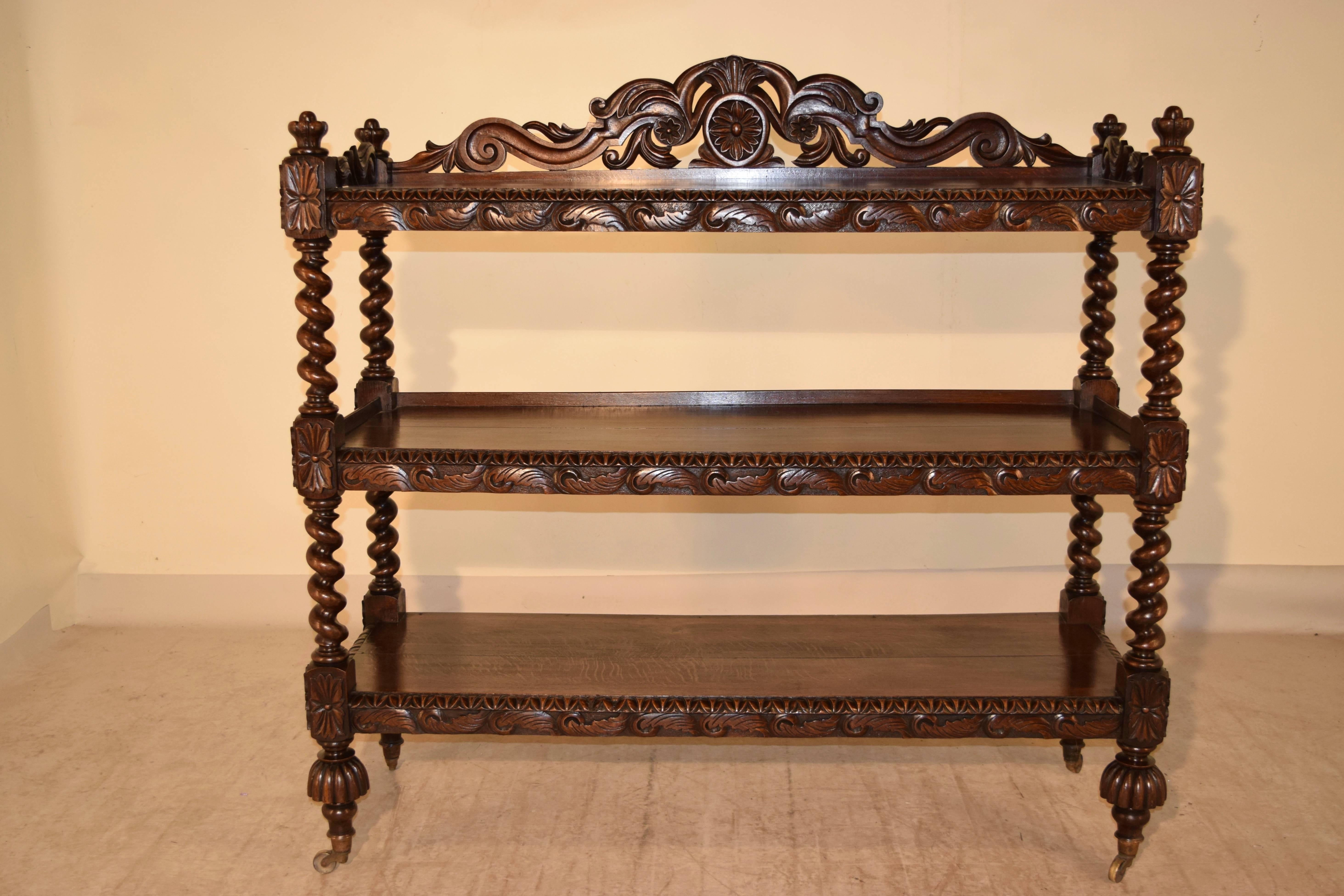 19th century large carved shelf from France which is fantastically carved throughout the piece. The back splash and top side rails are ornately carved with acanthus leaves and the top finials are hand-carved in the shapes of crowns. The shelves have