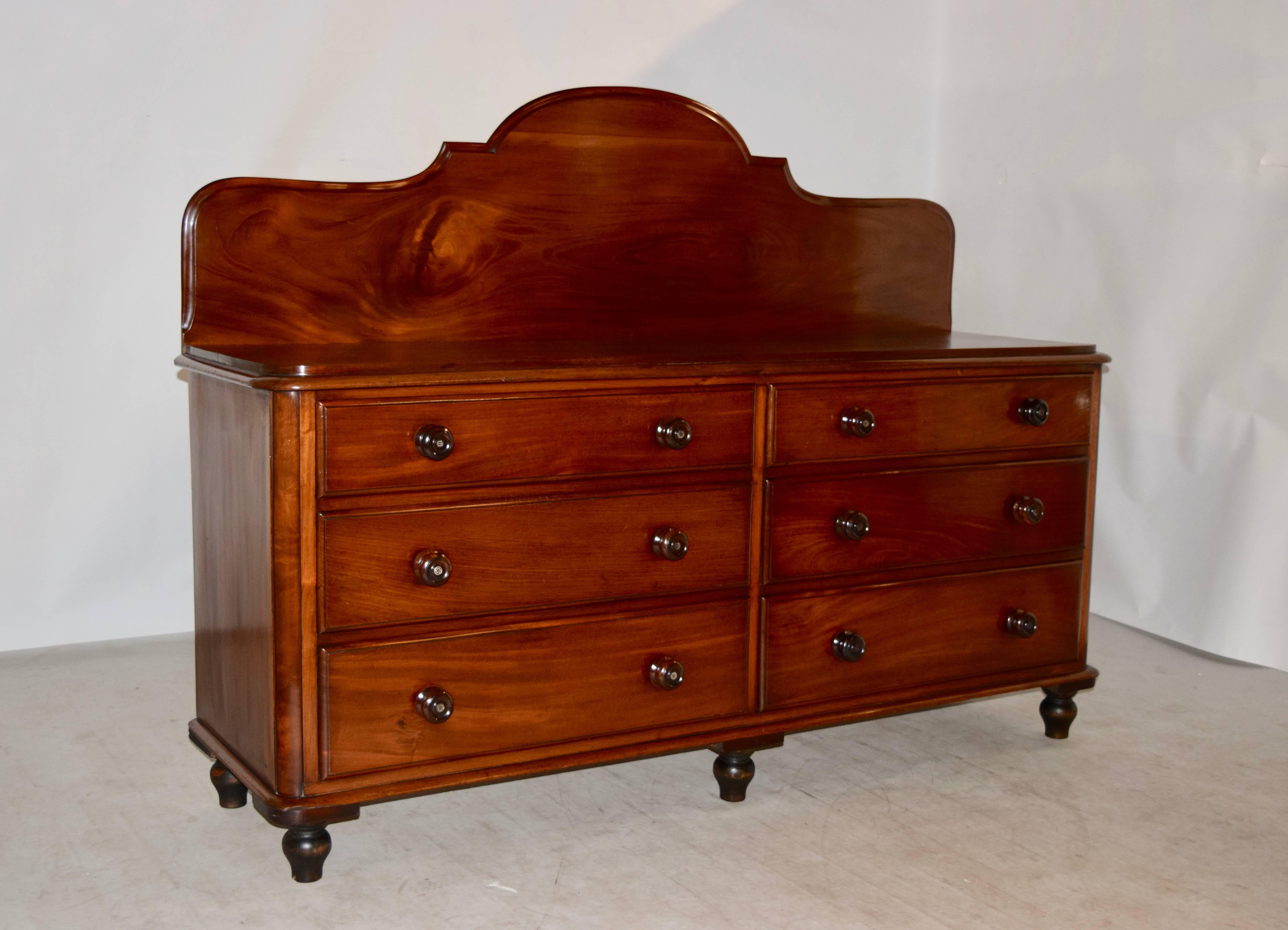 19th century English double dresser made from mahogany. The backsplash is removable, and is a lovely shape with scalloped and bevelled edges, following down to a wonderful single board top, which has rounded and molded corners. The case is simple on