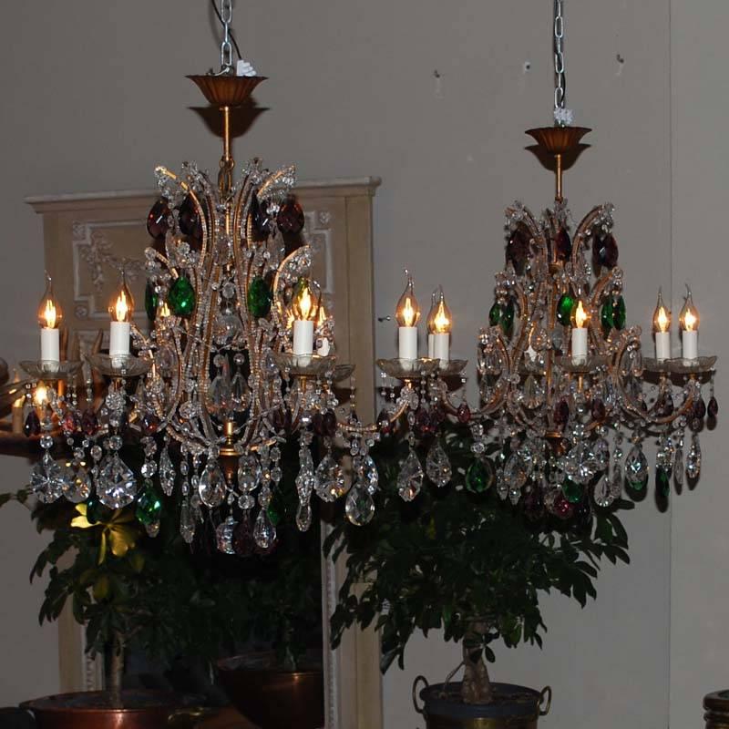 Magnificent pair of Italian Chandeliers.
Gilt frame with crystal beading alongside the frame.
Hung with transparant, green and purple crystal ornaments.
Originates Italy, dating app. 1960