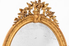 Eccezionale specchio ovale francese in legno dorato di epoca Napoleone III con vetro al mercurio originale