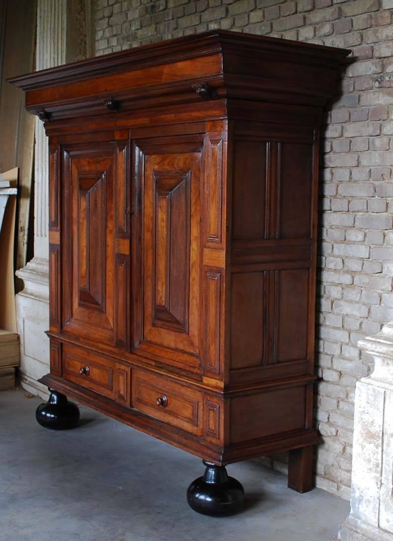 Dutch Renaissance cabinet with two doors and one drawer.
Made from solid oakwood with mahogany veneer.
This cabinet has a rare and authentic interior with two handcarved doors and three secret drawers.
The cabinet is in original condition. No big