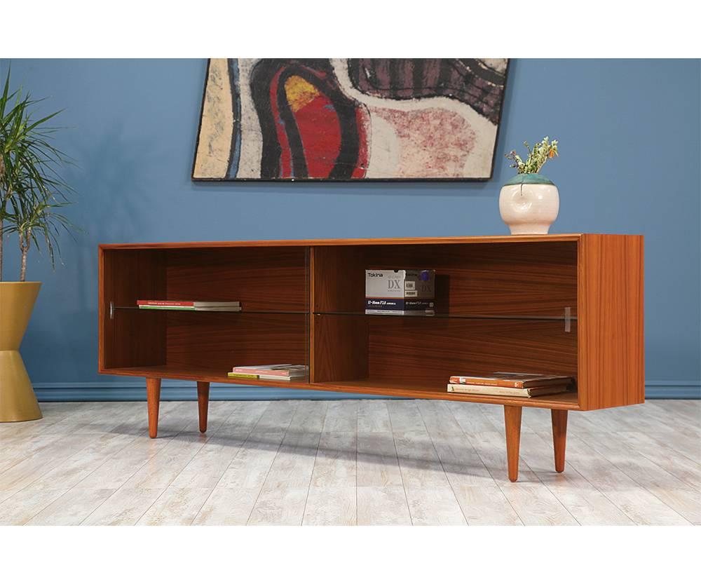 Period/style: Danish Modern
Country: Denmark
Date: 1960s

Dimensions: 26.25?H x 78?W x 12?D
Materials: Teak wood, glass doors
Condition: Excellent newly refinished
Number of items: Two available
ID number: 5013 and 5019.