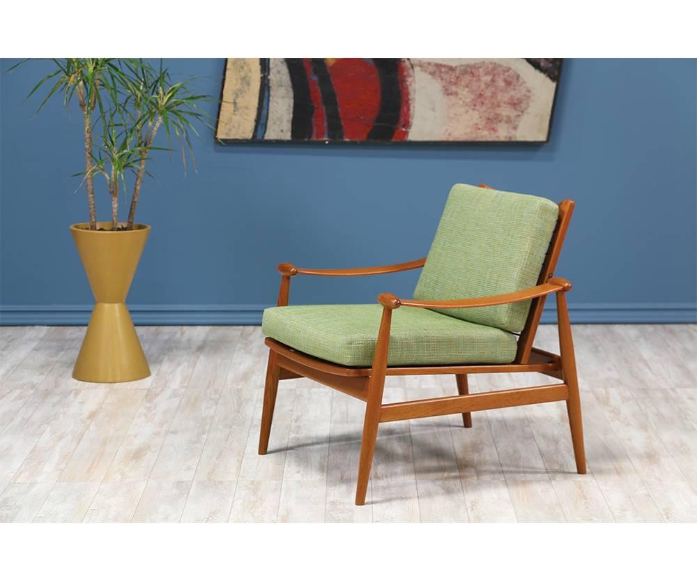 The Spade Lounge Chair designed by Danish Modern pioneer, Finn Juhl, for France & Søn circa 1950’s. This stunning chair, Model 133, has a refined teak wood frame and brass hardware details. It maintains the original vinyl-covered helical springs on