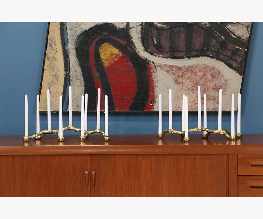 Pair of Mid-Century brutalist candelabras designed and manufactured in the United States circa 1970’s. These brass-plated aluminum candelabras feature a raw and natural appearance with age appropriate patina that enhances its brutalist aesthetic. 