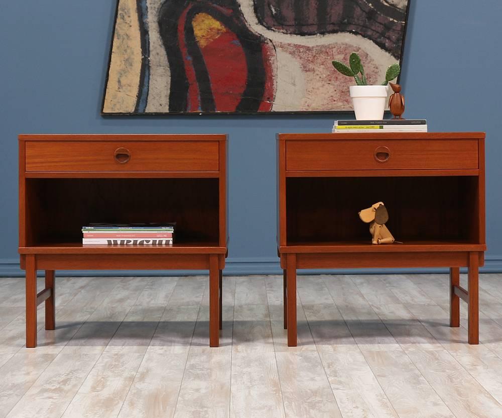 A pair of night-stands designed by Folke Ohlsson for Dux of Sweden manufactured c. 1960’s. These beautiful night stands feature a teak wood frame with clean lines, a drawer with circular, recessed pulls and an open compartment. The base exhibits