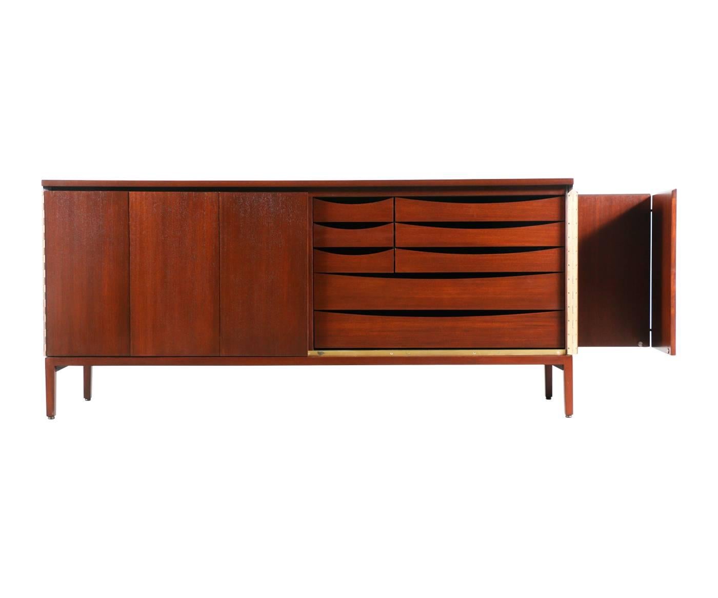 Designer: Paul McCobb.
Manufacturer: Calvin Group “Irwin Collection.”
Period/Style: Mid-Century Modern.
Country: United States.
Date: 1950s.

Dimensions: 32.25″ H x 71.25″ L x 19.25″ W.
Materials: Mahogany, brass.
Condition: Excellent newly