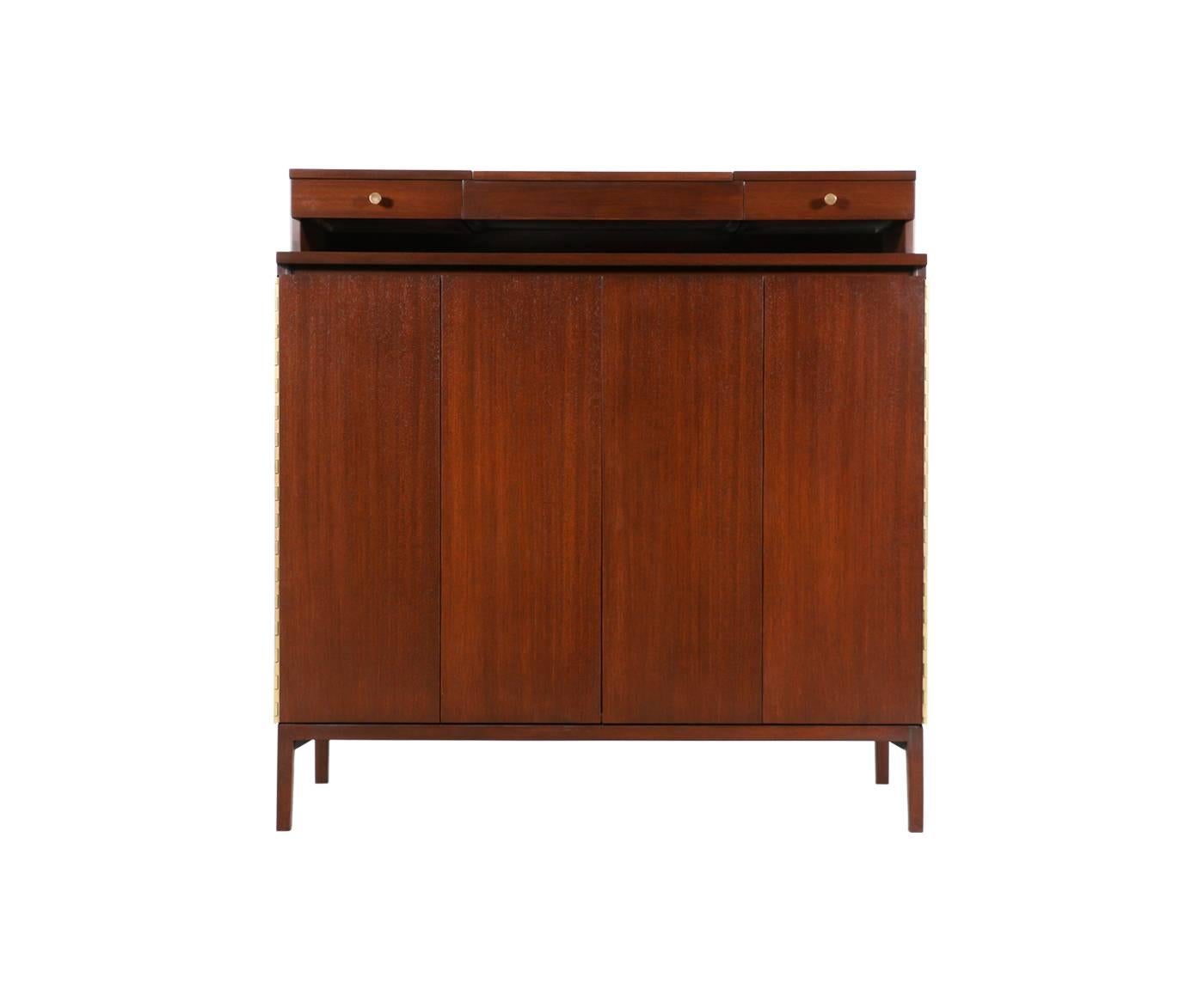 Designer: Paul McCobb.
Manufacturer: Calvin Group “Irwin Collection.”
Period/Style: Mid-Century Modern.
Country: United States.
Date: 1950s.

Dimensions: 49.75″ H x 48″ W x 19″ D.
Materials: Mahogany, brass.
Condition: Excellent – newly
