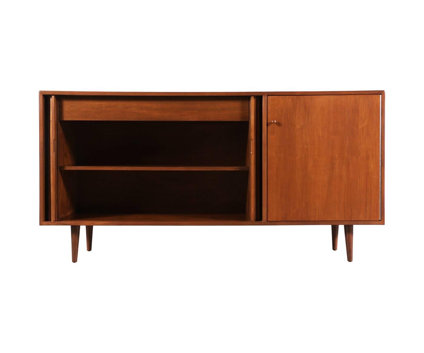 Designer: Milo Baughman.
Manufacturer: Glenn of California.
Period/Style: Mid-Century Modern.
Country: United States.
Date: 1950s.

Dimensions: 32.75″ H x 64.75″ W x 17.75″ D.
Materials: Walnut.
Condition: Excellent. Newly