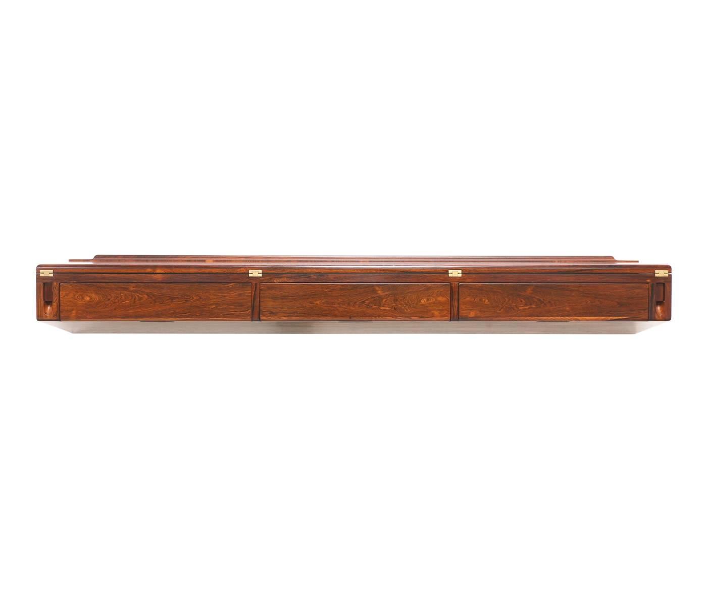 Designer: Arne Hovmand-Olsen.
Manufacturer: Arne Hovmand-Olsen.
Period/Style: Danish modern.
Country: Denmark,
Date: 1960s.

Dimensions: 7.75″ H x 59″ W x 12″ D.
Total extension 11″.
Materials: Rosewood, brass.
Condition: Excellent, newly