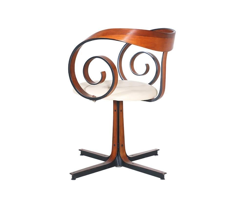 Designer: George Mulhauser
Manufacturer: Plycraft
Period/style: Mid-Century Modern
Country: United States
Date: 1950s

Dimensions: 27.75? H x 25? W x 25? D
Seat height 17.5?
Materials: Laminated walnut bentwood, leather seat
Condition: