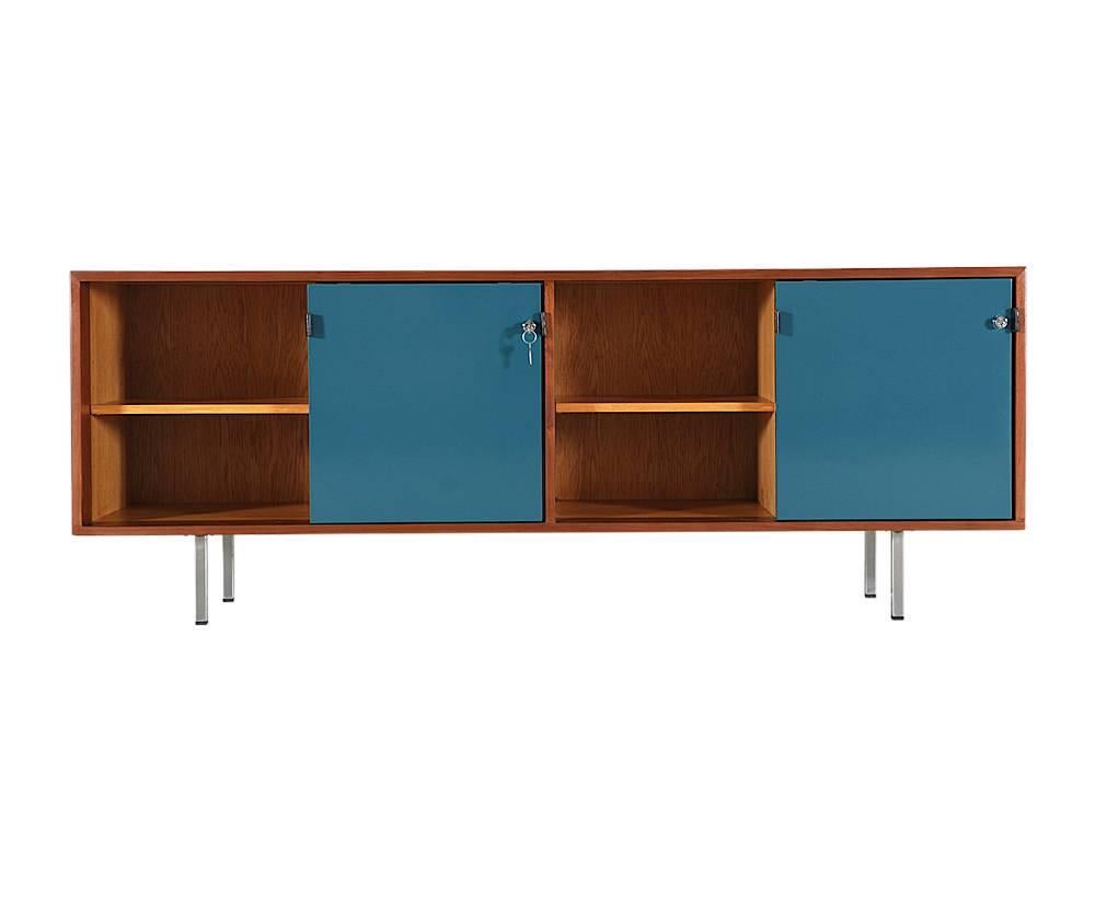 Designer: Florence Knoll
Manufacturer: Florence Knoll Inc.
Period/Style: Mid-Century Modern
Country: United States
Date: 1950s

Dimensions: 27.5 H x 17.75 W x 72 L
Materials: Walnut wood, Leather pulls, lacquered doors, steel legs
Condition: