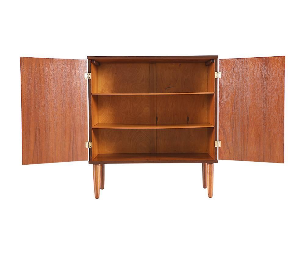 Designer: Hans Olsen
Manufacturer: Hans Olsen studio
Period or style: Danish Modern
Country: Denmark
Date: 1950s

Dimensions: 37 H x 33.25 W x 16.5 D
Materials: teakwood, brass hardware
Condition: excellent newly refinished
Number of items: