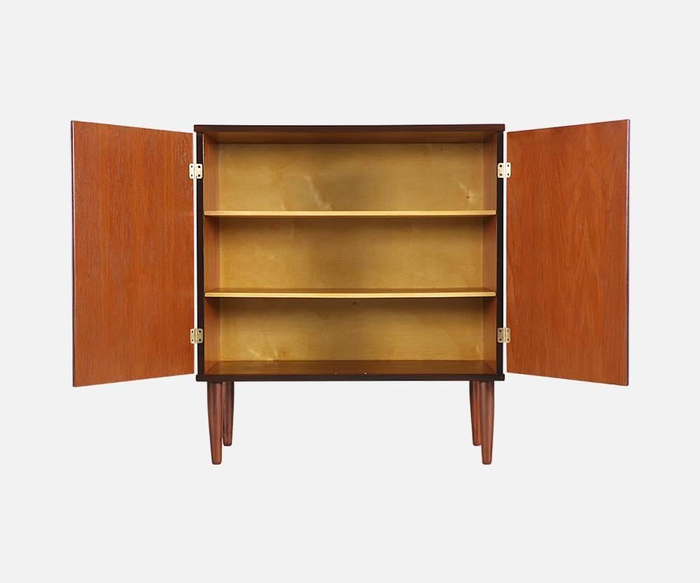 Designer: Hans Olsen
Manufacturer: Hans Olsen Studio
Period or style: Danish Modern
Country: Denmark
Date: 1950s

Dimensions: 36.75 H x 33.25 W x 16.5 D
Materials: Teak wood, brass hardware
Condition: Excellent – newly refinished
Number of