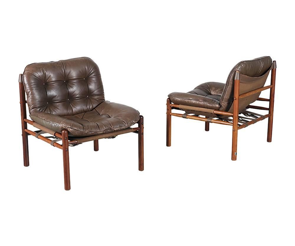 Designer: Arne Norell
Manufacturer: Scanform
Period/style: Mid-Century Modern
Country: Colombia
Date: 1950s

Dimensions: 29.5 H x 26.5 W x 27 D
Seat height 16
Materials: Rosewood, original leather
Condition: Leather seats show normal wear