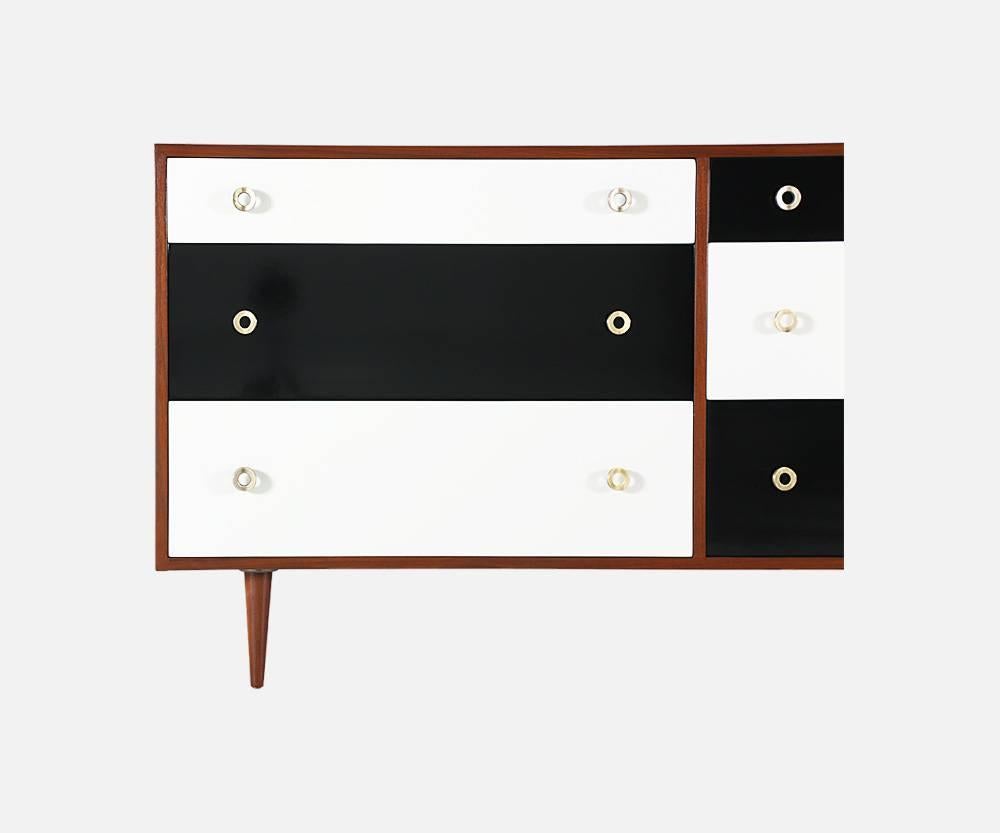 Designer: Greta M. Grossman
Manufacturer: Glenn of California
Period/Style: Mid-Century Modern
Country: United States
Date: 1950s

Dimensions: 32.75?H x 64.75?L x 18?W
Materials: Walnut wood, brass, lacquered paint
Condition: Excellent,