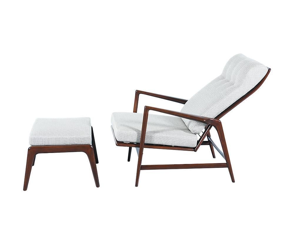 Designer: Ib Kofod-Larsen
Manufacturer: Selig
Period/Style: Danish Modern
Country: Denmark
Date: 1960s

Dimensions: 37?H x 28.5?W x 36?D
Seat height 16?
Ottoman 15.5?H x 23.5?W x 21?D
Materials: Beech with walnut finish, tweed