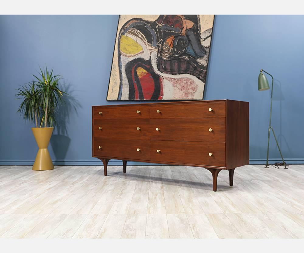 Designer: Richard Thompson
Manufacturer: Glenn of California
Period/style: Mid-Century Modern
Country: United States
Date: 1950s

Dimensions: 30.5?H x 64.75?W x 17.75?D
Materials: Walnut, brass pulls, plywood legs
Condition: Excellent, newly