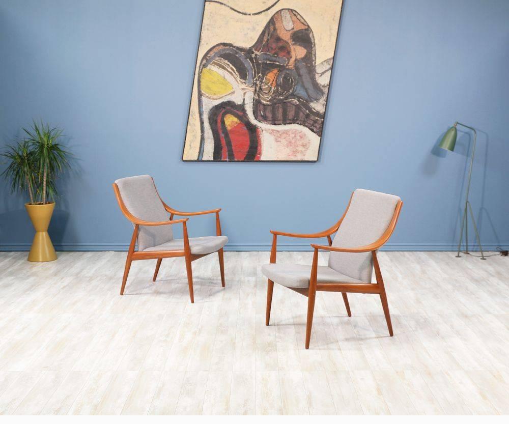 Stunning Peter Hvidt & Orla Mølgaard-Nielsen Lounge Chairs designed for France & Søn in Denmark circa 1950's. This design uses quality teak wood and a few studio craft techniques including laminated bentwood curvilinear arms and beautifully exposed