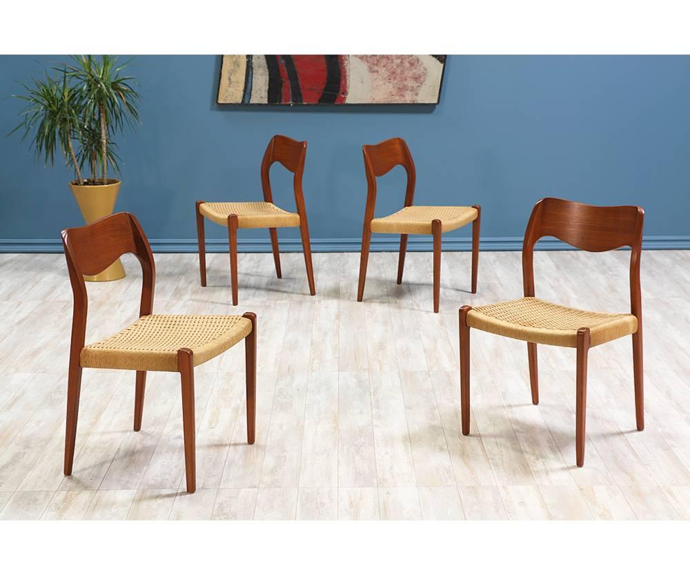 Set of four Model #71 dining chairs designed by Arne Hovmand-Olsen for J.L. Møllers Møbelfabrik in Denmark circa 1970’s. This classic set of dining chairs feature their original finish in good condition as well as the original rush cord with very