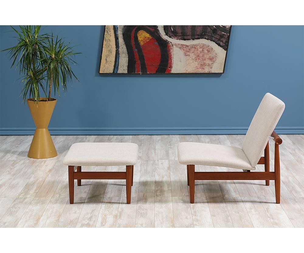 Model 137 lounge chair and footstool designed by Danish Modern icon Finn Juhl for France & Søn in Denmark c. 1950’s. This stunning, low-profile lounge chair features a solid teak wood frame constructed with a clean, linear design and is newly