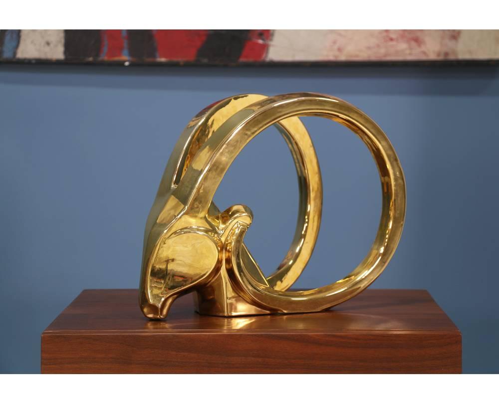 Mid-Century cubist sculpture crafted by Jaru of California. This Ibex head sculpture finished in gold plated glaze over ceramic shows minor wear. A lovely piece of art that would sit nicely inside an etagere or on a side table.