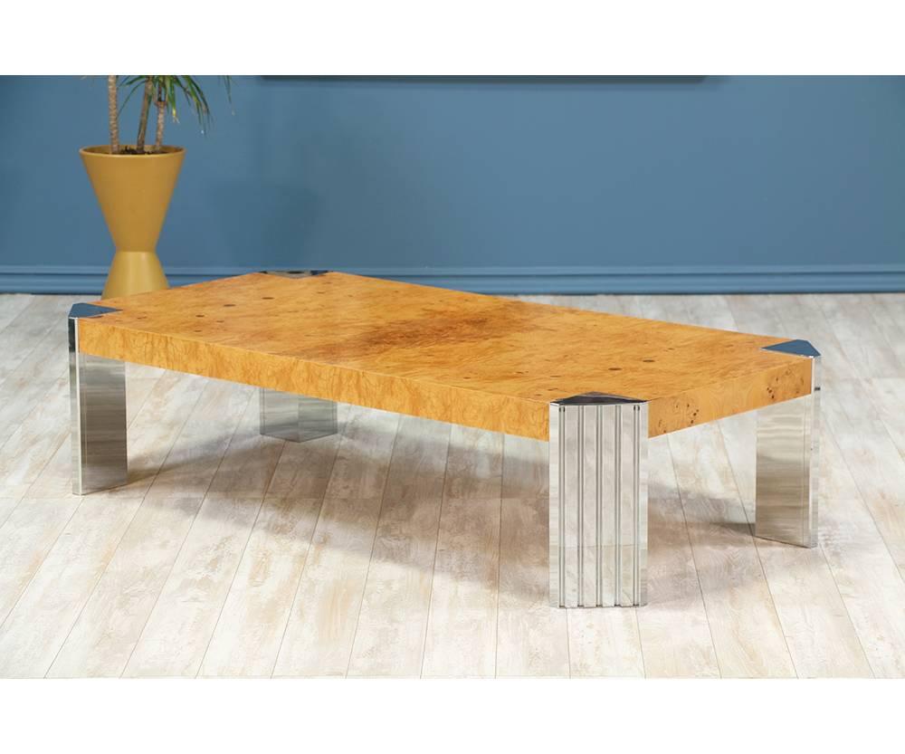 Coffee table designed and manufactured in the United States circa 1970’s. This spectacular coffee table features an olive burl wood top with an intricate wood grain that is beautifully contrasted with four newly re-chromed legs. This unique table