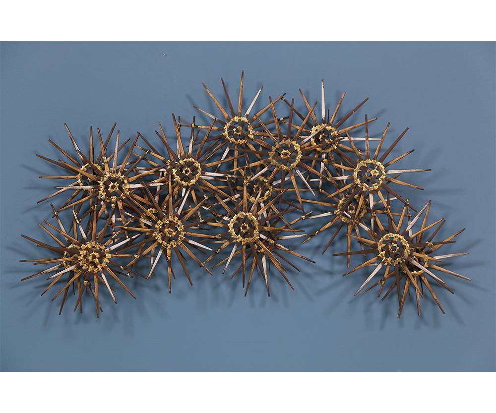 Starburst wall sculpture by American artist and inventor Marc Weinstein for Marc Weinstein Studio in 1960’s. Impressive hand-forged sculpture made of brass, copper, and steel with gold and silver details in the painting. With an age-appropriate