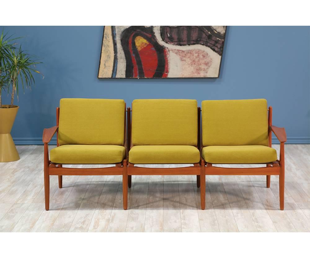 Three-seater sofa designed by Danish modernist, Svend Åge Eriksen, and manufactured in Denmark by Glostrup Møbelfabrik in the 1960’s. Featuring a teak wood frame with beautiful grain and reupholstered high density foam cushions in a new vibrant