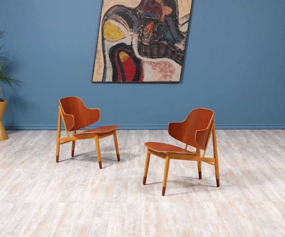 Pair of spectacular shell chairs, crafted by Danish architect and furniture designer Ib-Kofod Larsen, and manufactured by Christensen & Larsen A/S in the 1950’s. Kofod Larsen’s versatility to work with different types of wood, in this case creating