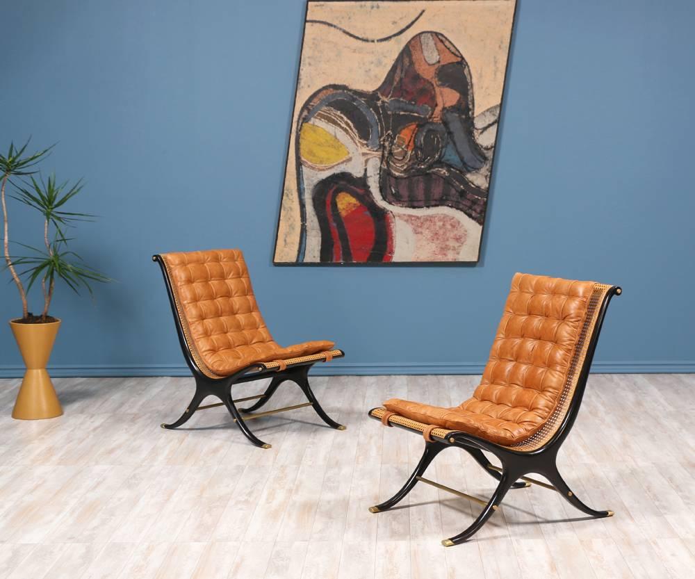 Mid-Century Modern Scoop lounge chairs designed by Gerald Jerome and manufactured in the United States by Heritage Furniture in the 1960’s. Sculptural, lacquered mahogany X-frames with new caning and brass components. These beautiful chairs have