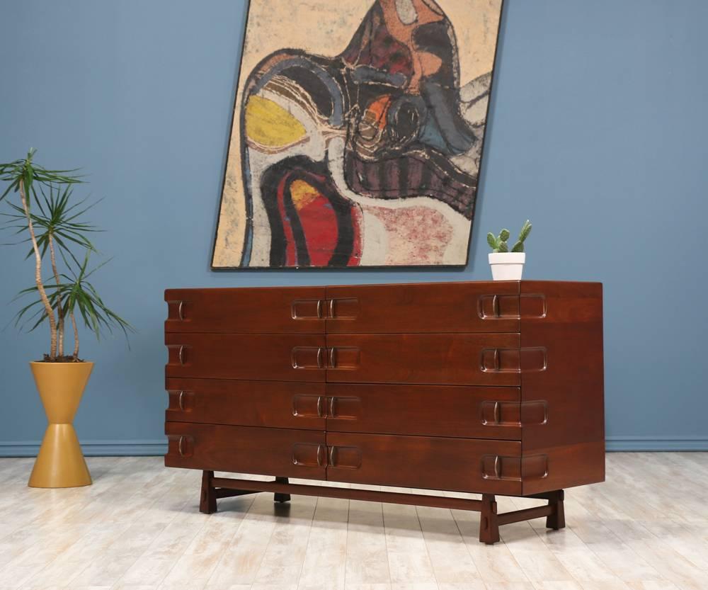Mid-Century Modern dresser by American furniture designer Edmond J. Spence and manufactured by Industria Mueblera S.A. of Mexico in the 1960’s. A beautiful Mexican modernist design crafted from mahogany wood featuring lovely bronze handles that