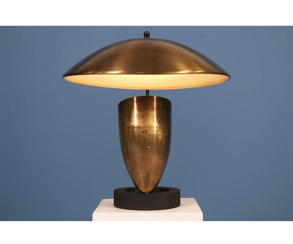 Modernist bronze table lamp by North American designer Robert Bulmore manufactured by Bulmore MFG Co. in the 1950’s. A mid-century modern item with a timeless look. Made of bronze, this lamp sits on an iron base and is newly rewired for optimal