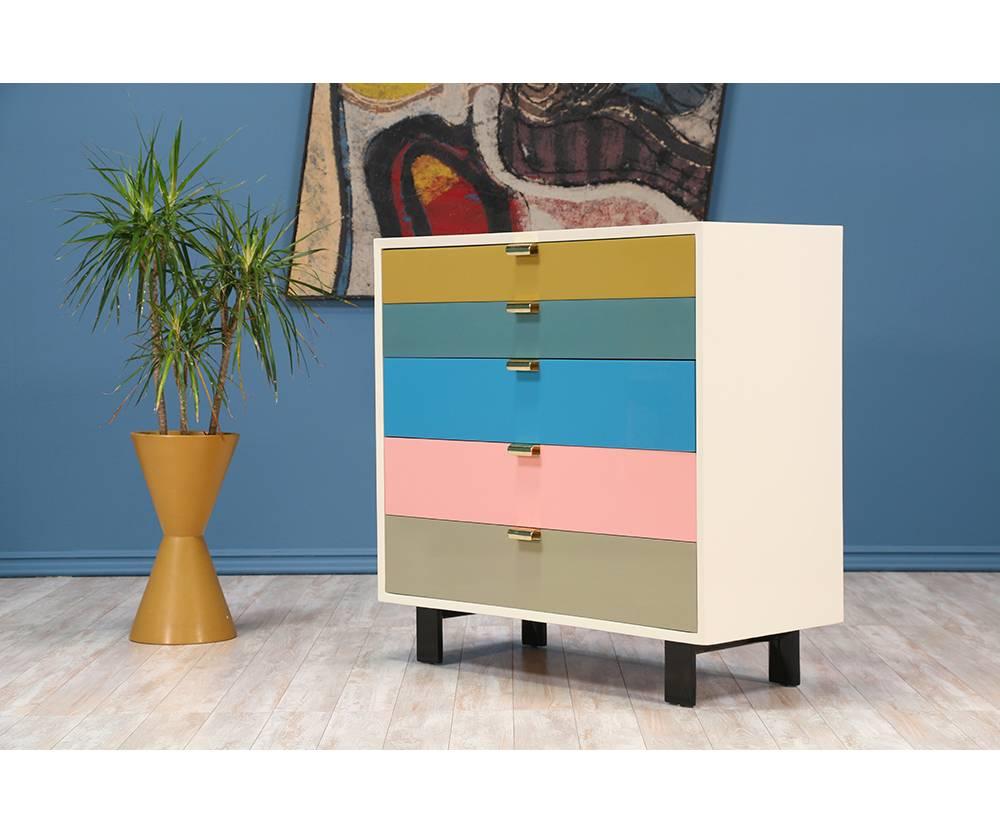 Chest of drawers designed by the iconic George Nelson for Herman Miller circa 1950’s. This chest has been re-lacquered in the original colors – pastel drawers, white casing and black feet. The drawers are adorned with signature brass pulls that open