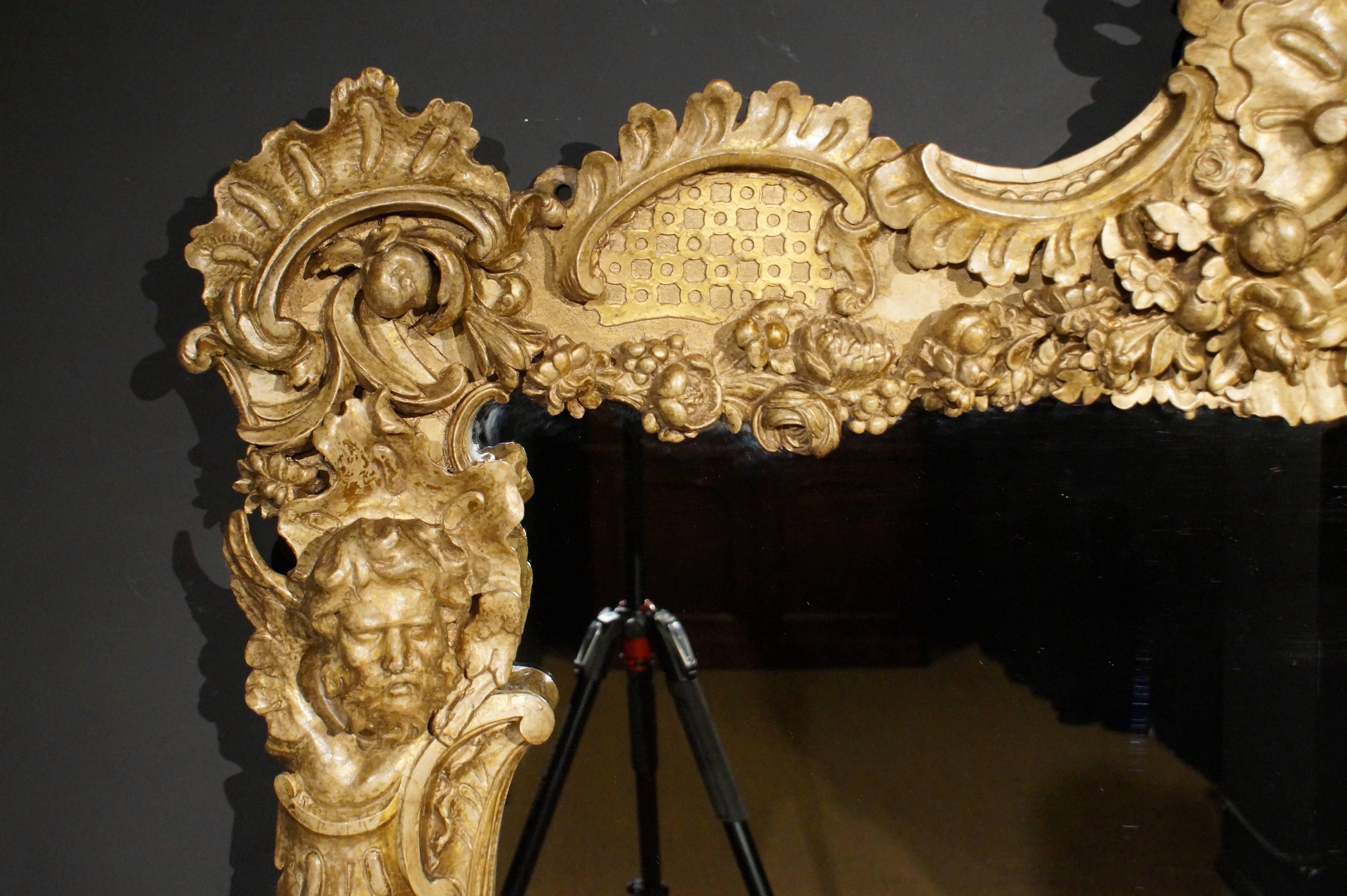 A fabulous early 19th century composition Rococo Revival overmantel mantel mirror retaining the maker's label, by William Freeman of Norwich. 
A Rococo console table made by Freeman with the same technique and style is in Blickling Hall, Norfolk.