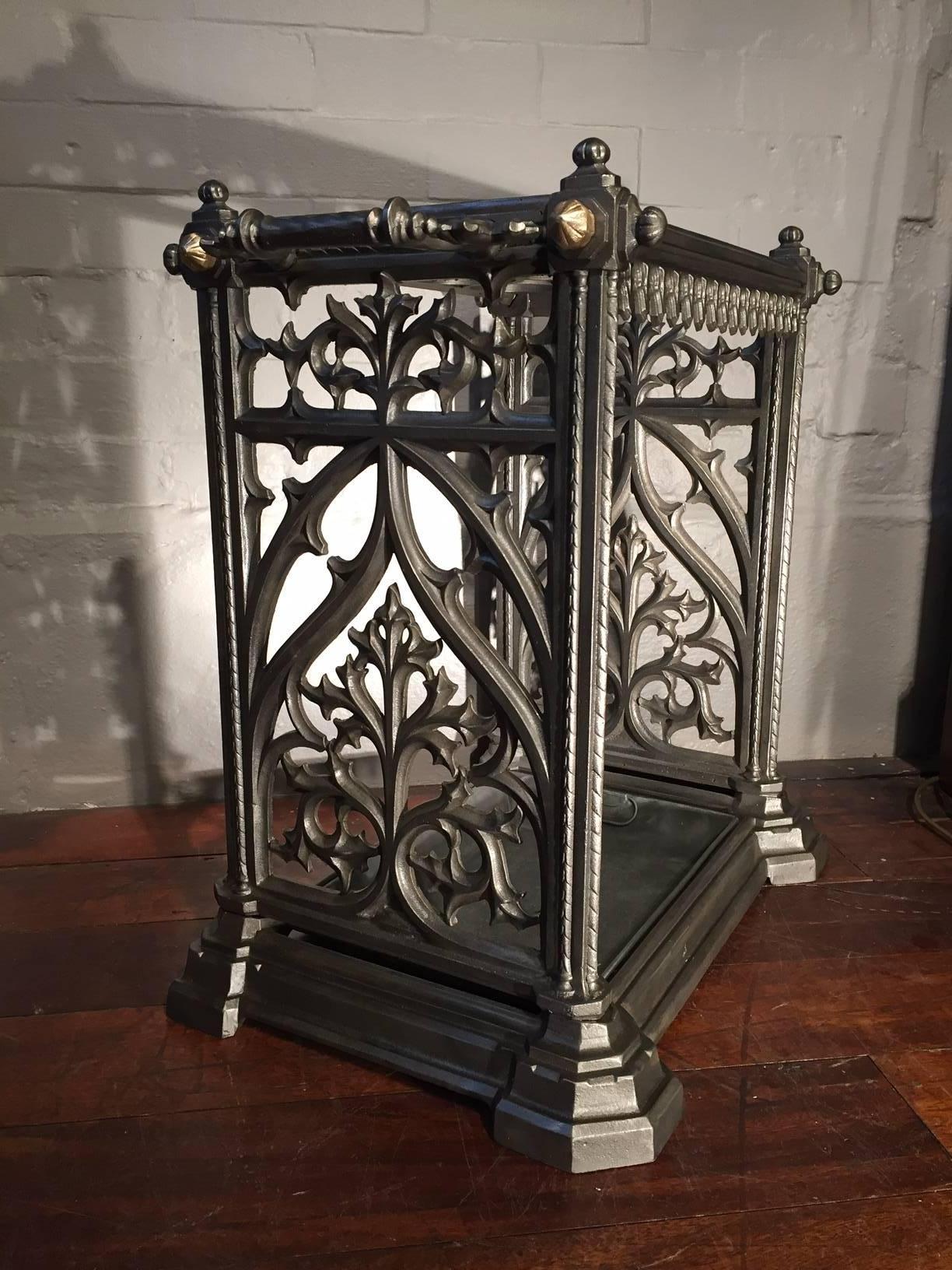A decorative and most unusual Victorian cast iron umbrella and stick stand with 12 circular dividers and ornate pierced sides on a moulded base.