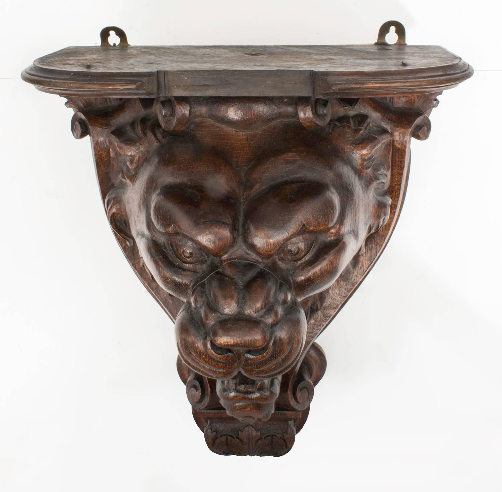 Dramatic solid wood carved lion wall shelf. Stained dark sculptural head.
Fierce looking with open mouth. Very well carved.
Top is a platform for display of plant or etc.
