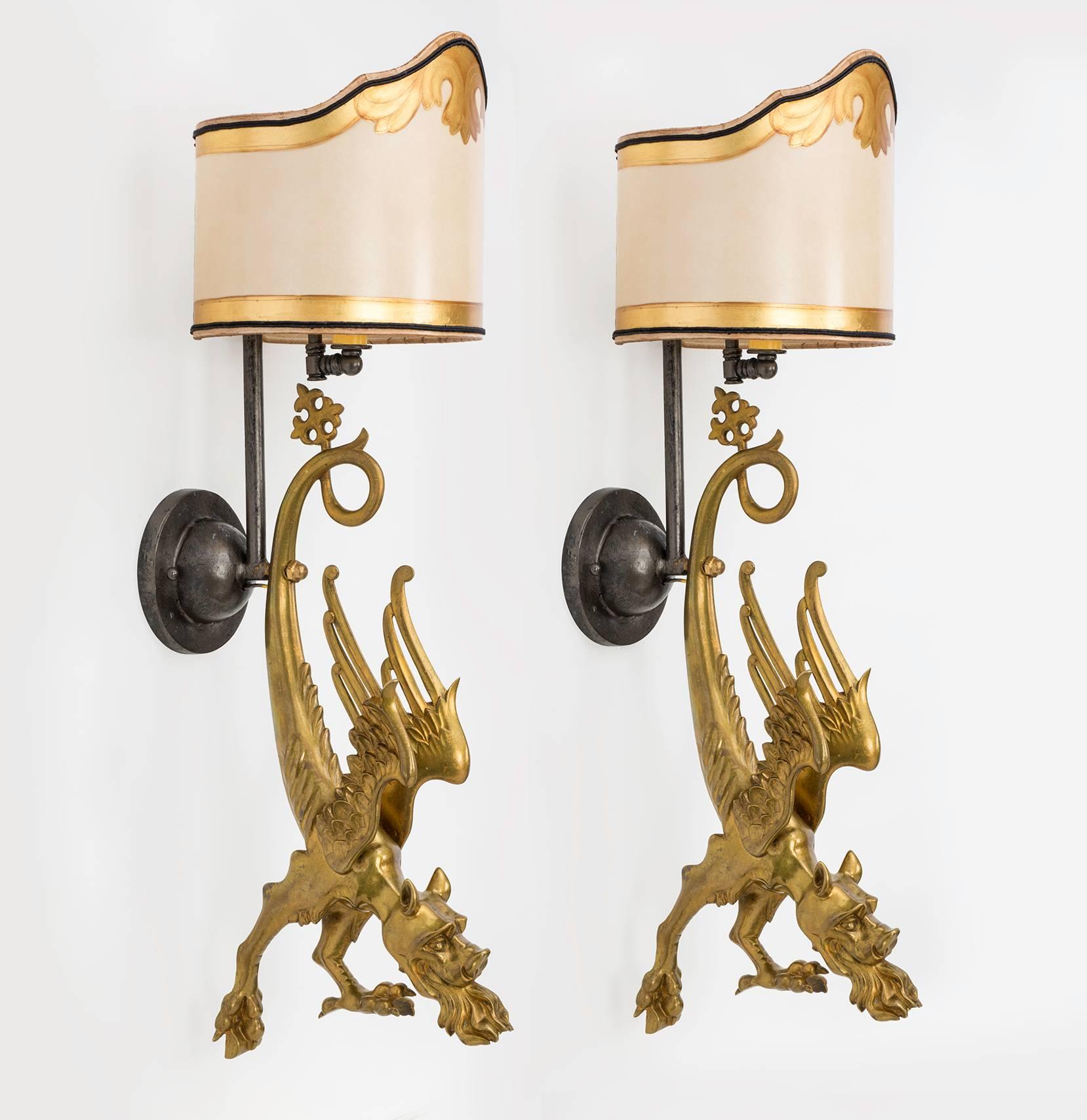 As found, pair of early 1920s gilt  Bronze dragons made into a very charming fire breathing dragon wall sconces. There are wall lights as well as flickering lights from its mouths. Dragons are beautifully cast bronze in gilt finish. Shades are