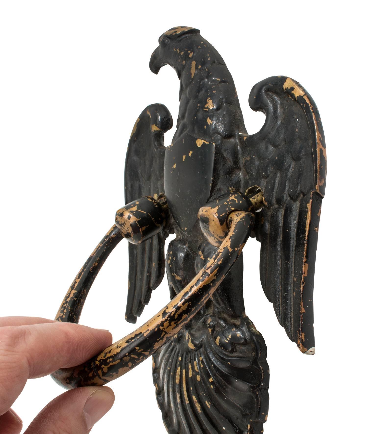 Aged nicely over the years, peeling black paint with under brass showing.
Handsome American Eagle door knocker. Adding charm to any doors.
