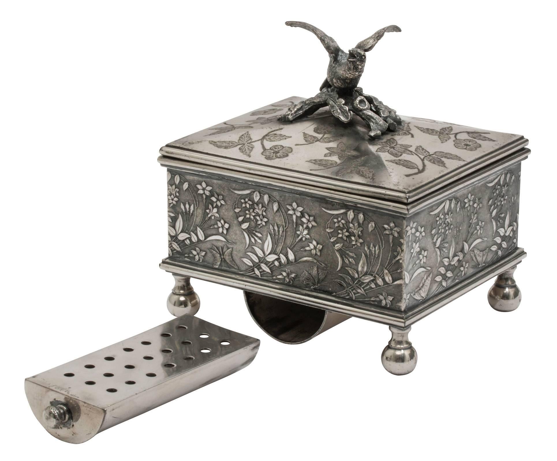 Aesthetic Movement, Victorian butter box. Silver plated, hinged lid with dove figurine, slider ice tray.
All-over etched florals on the lid and side panels are embossed florals.