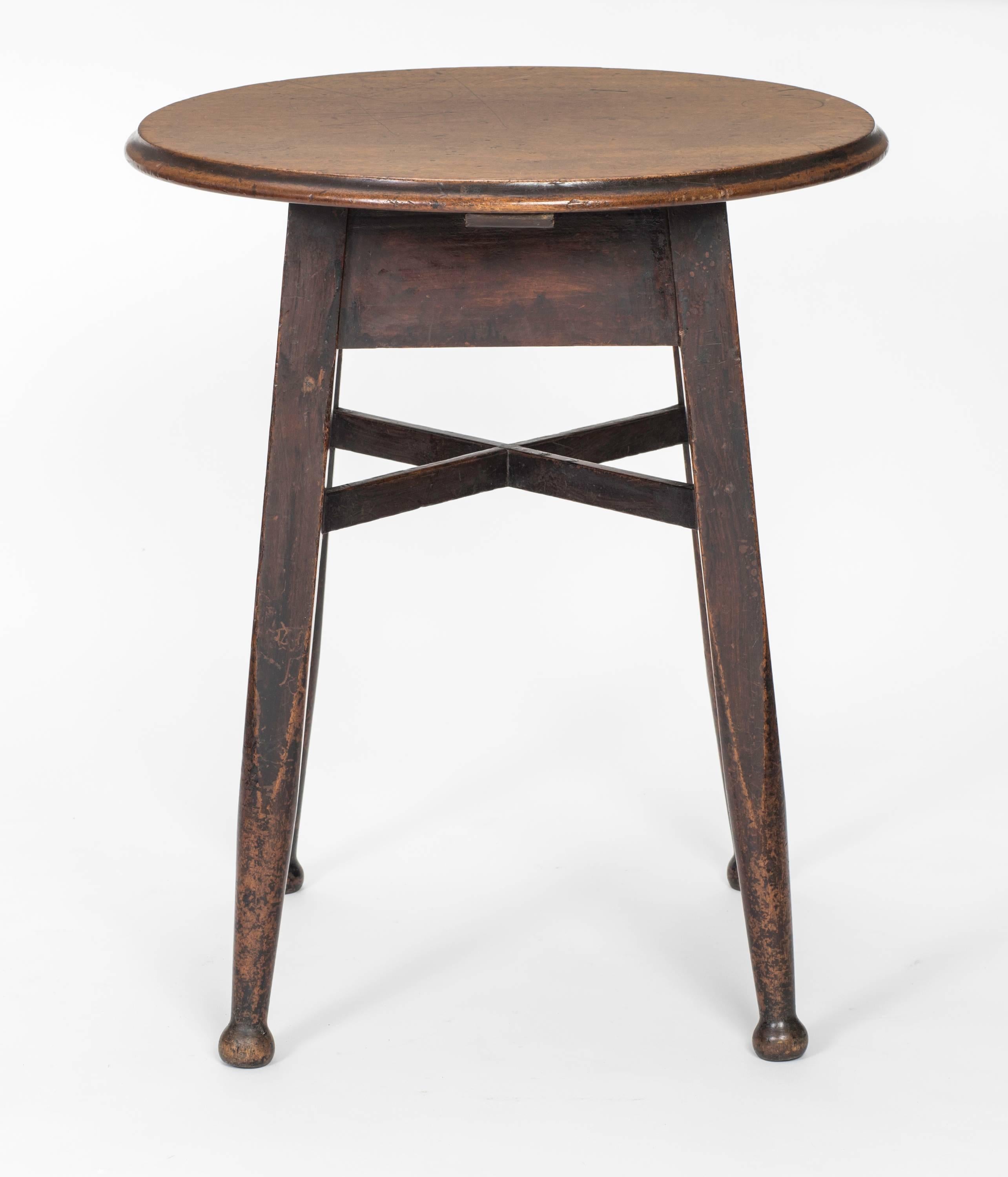 Walnut wood, warmly aged round side table, circa 1900s, England. Supported by four tapered legs with cross bar stretchers and small bun feet. Very charming table.