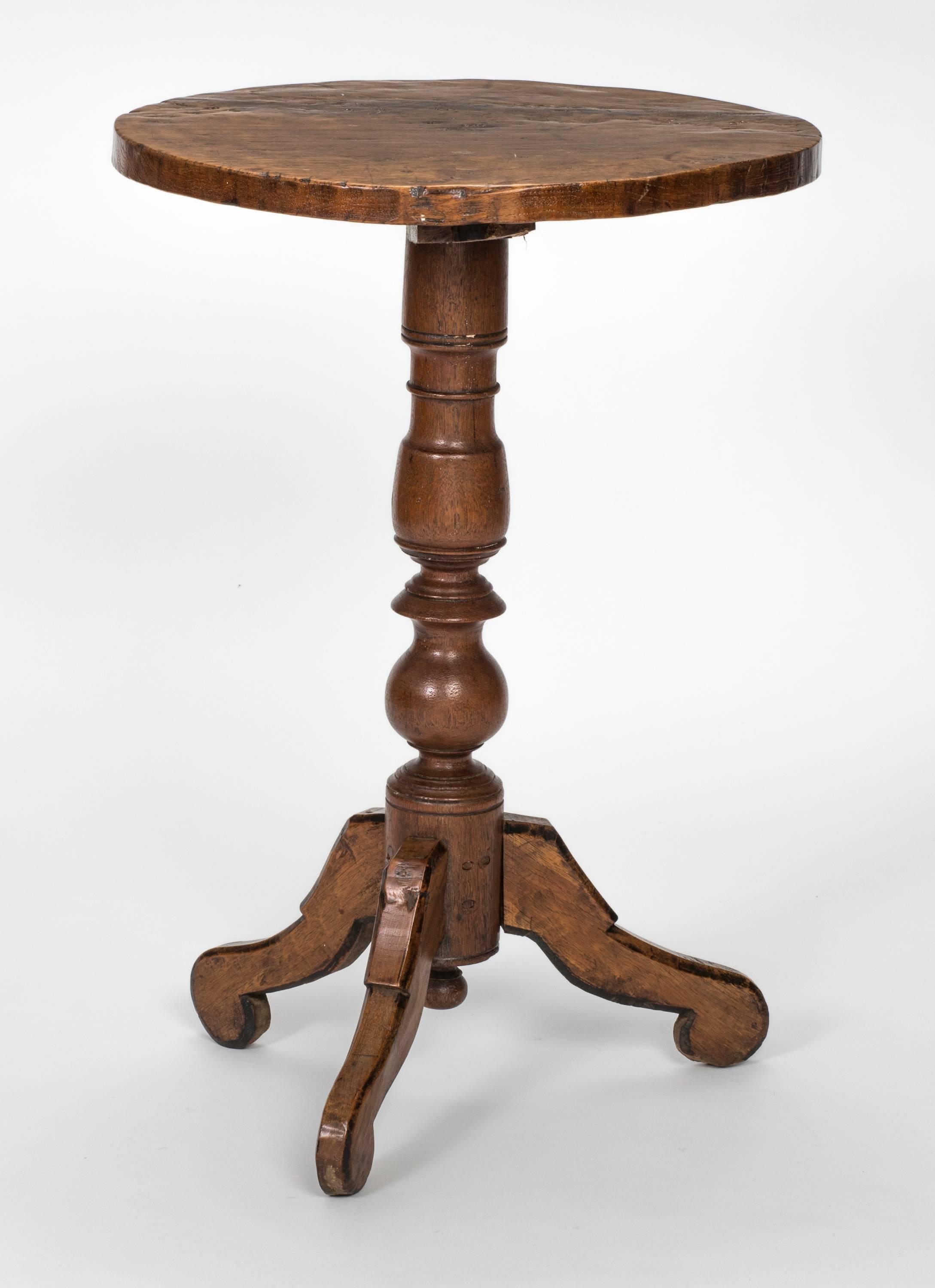 19th century French petit round pedestal table. Nicely worn rustic wood top. Handmade with mixture of wood. Base is elegantly turned pedestal with tripod feet. Great little side wine table.