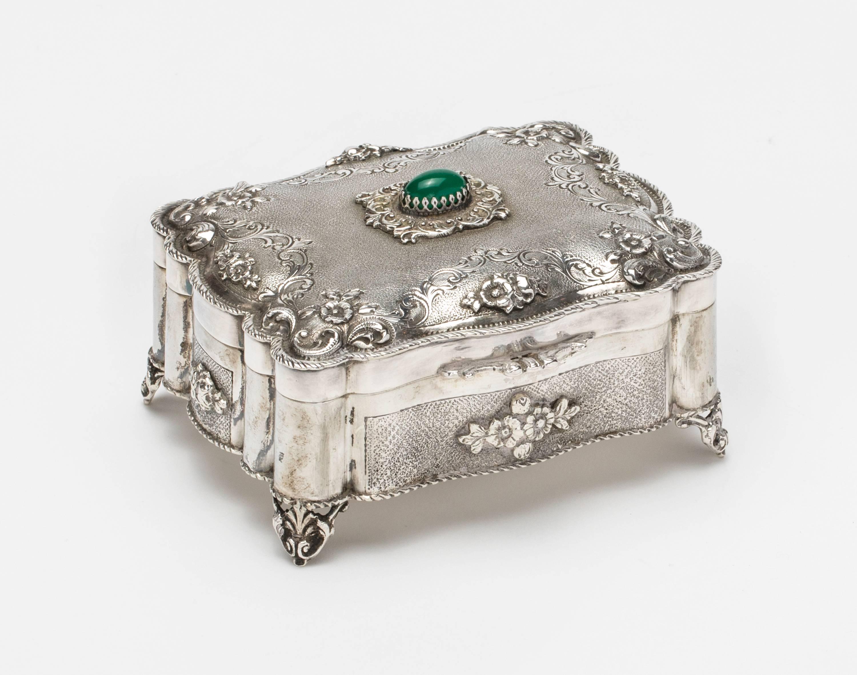 German 800 silver, circa 1900s. Beautifully made, scalloped shape sides. Etched and chased superbly, sits on small raised feet. Decoratively topped with beautiful green Jewel Chalcedony stone. With lid wide open, the box stands 5.5