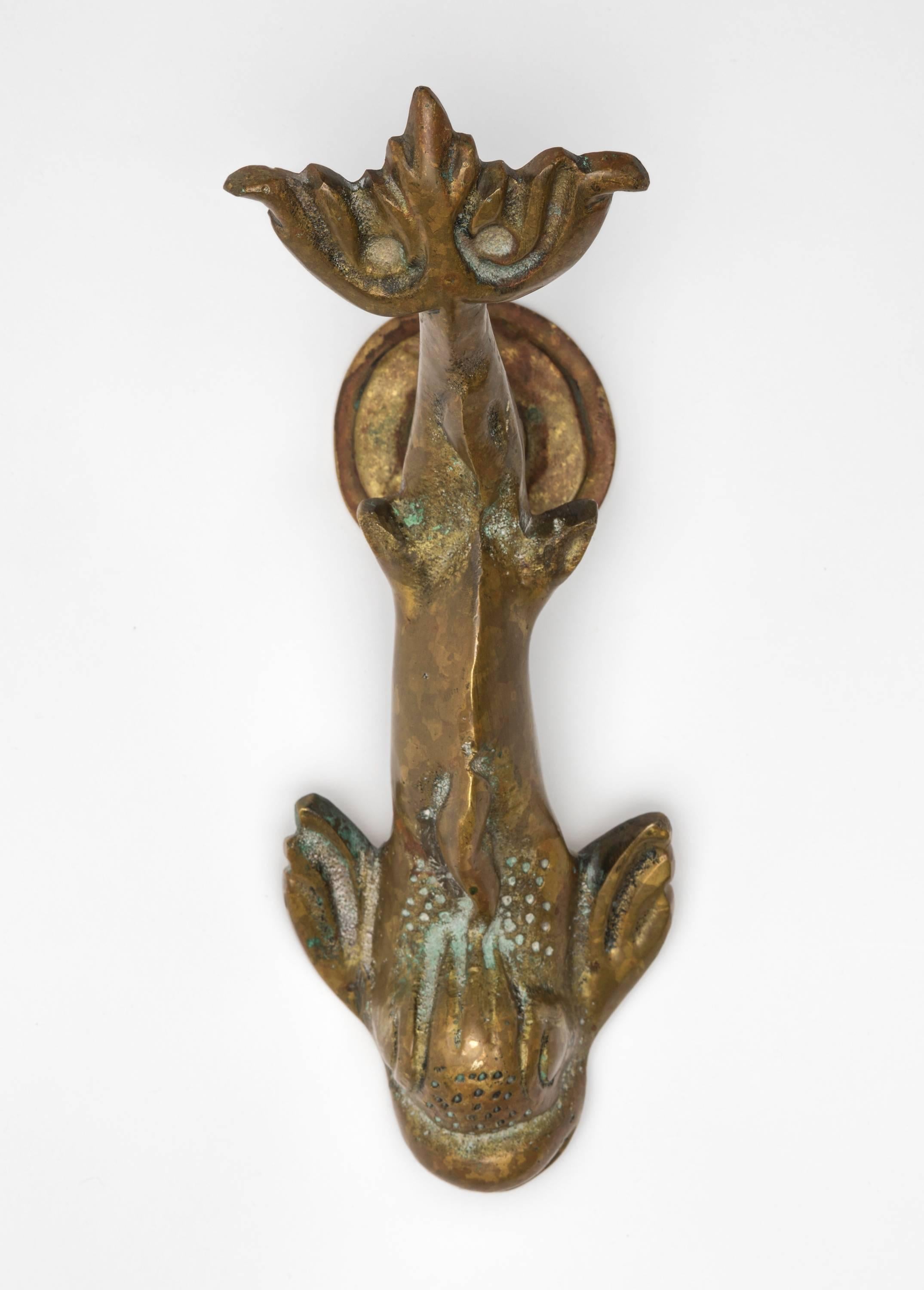 Old cast brass dolphin door knocker, circa 1920s. Nicely worn and aged.
A very charming piece.