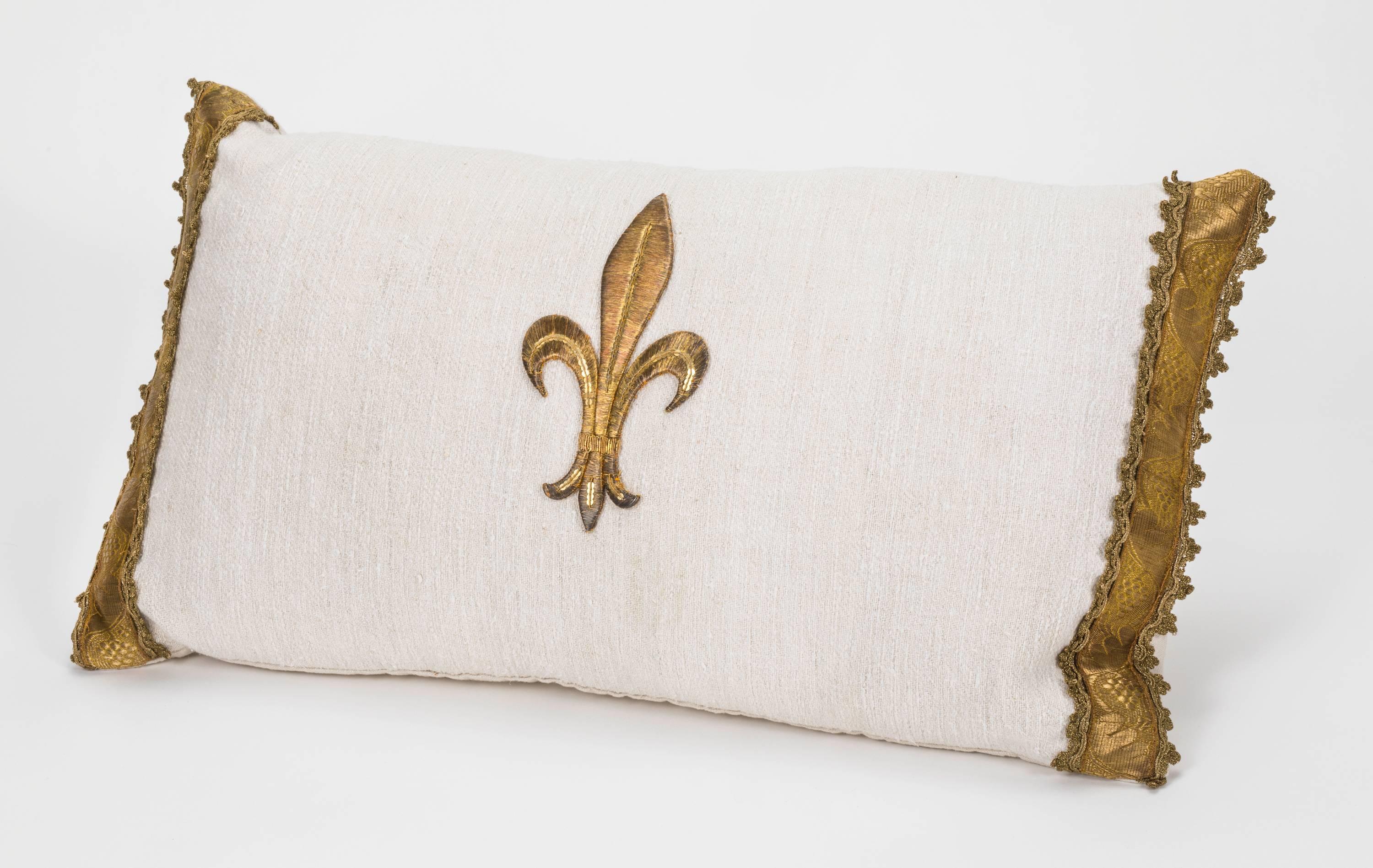 Beautifully hand made linen pillow with antique metallic gold thread fleur-de-lis appliqué. Sides are also trimmed with antique metallic gold trim. One of a kind. Down feather insert.