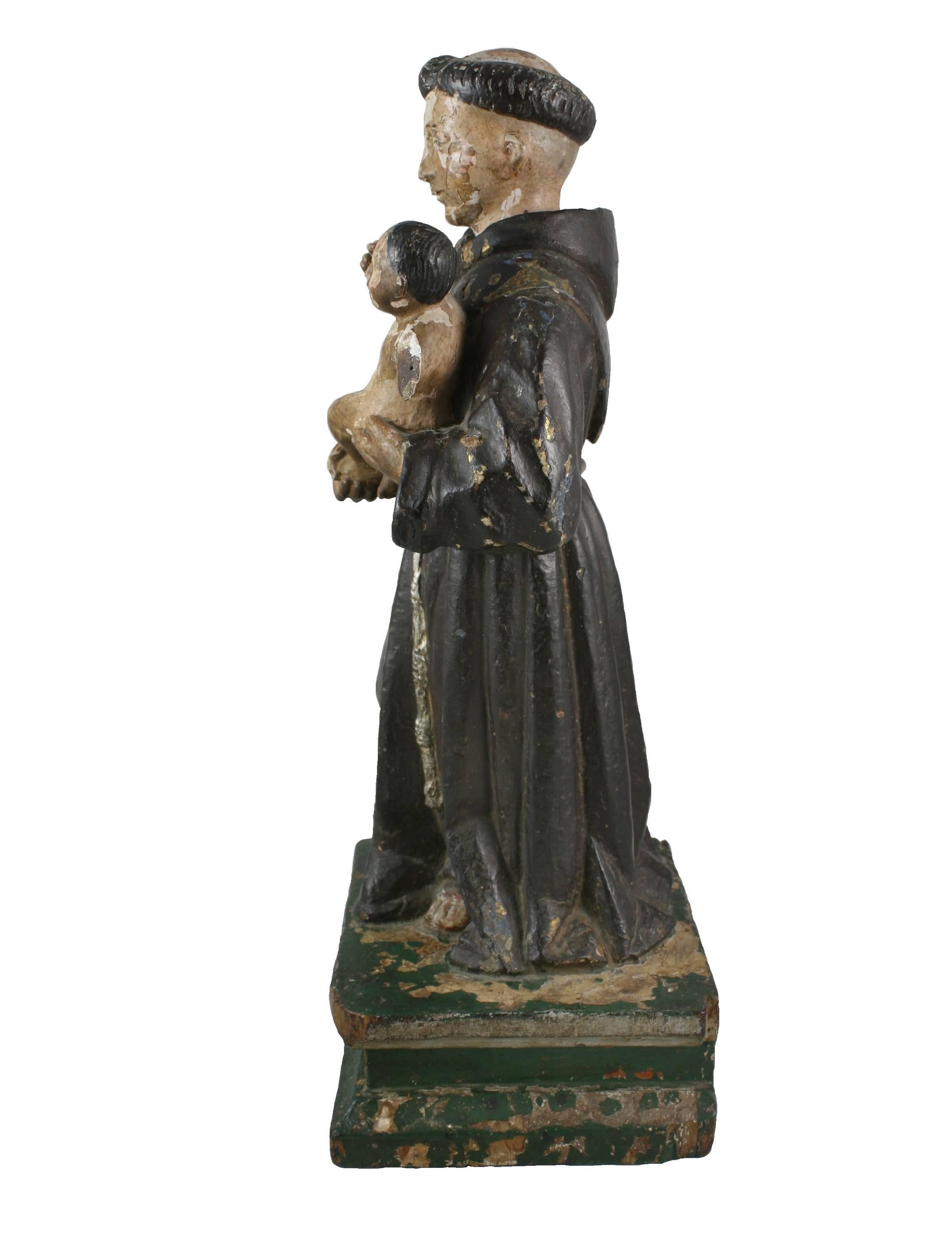 Hand-carved polychrome wood santo of Saint Anthony of Padua. Traditionally depicted, wearing friars robes and holding the infant Jesus. A lovely example of Spanish Colonial devotional art.
 Saint Anthony of Padua is the patron saint of lost