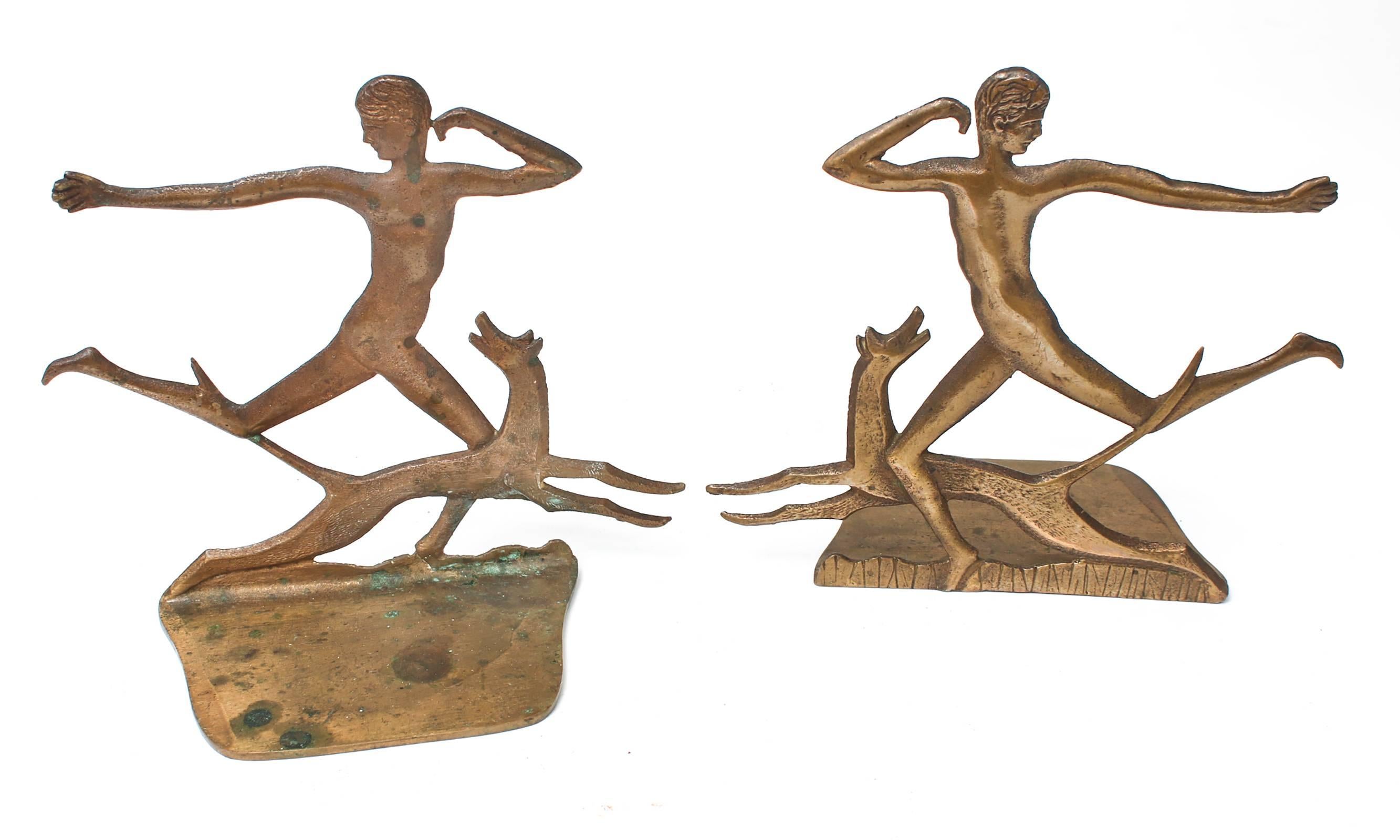 Charming pair of bronze male figures in midst of running with a dog.
Art Deco style from 1900s. Very decorative with details on both sides.