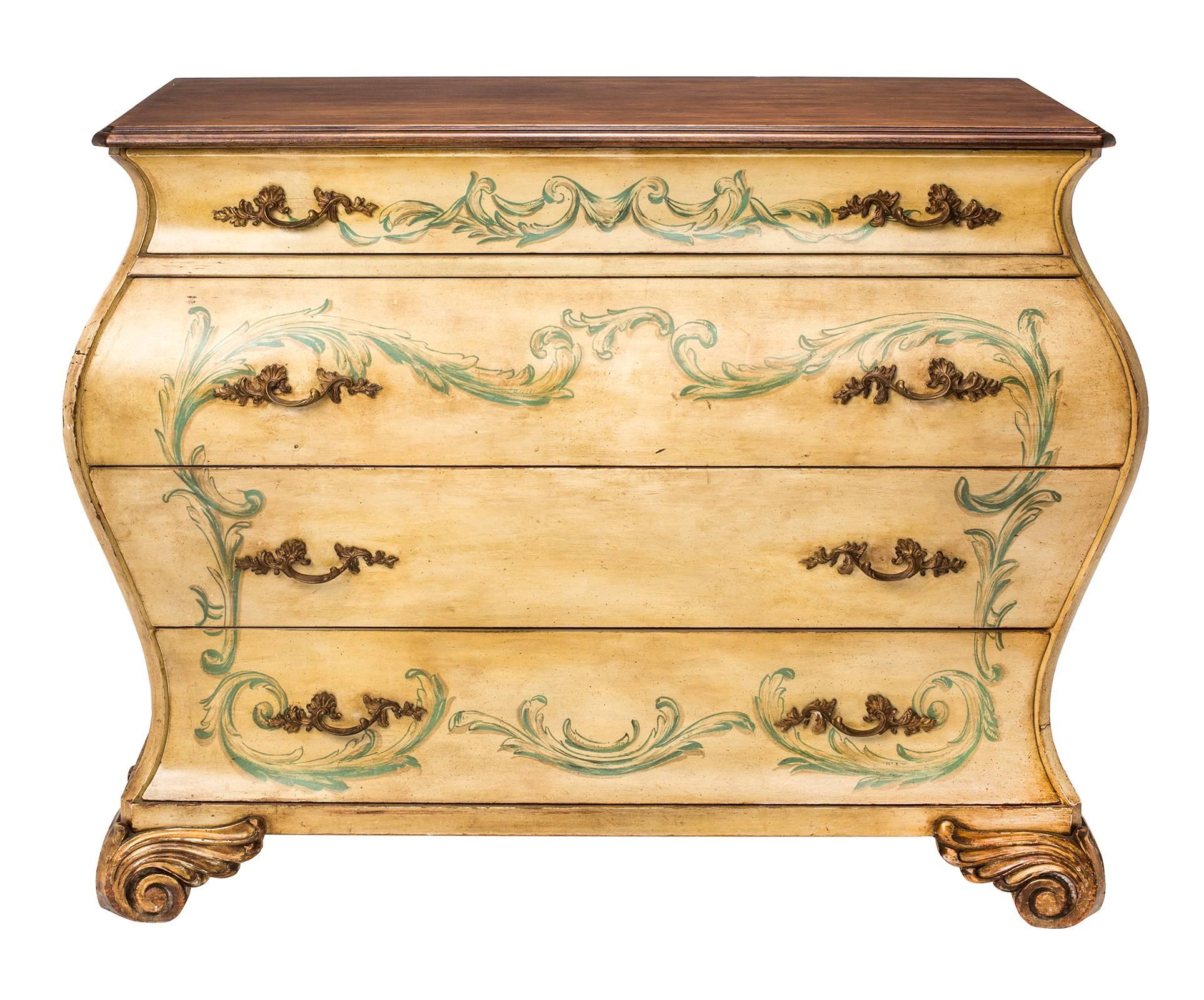 A wonderful painted Bombe chest of drawers. Graduating four drawers with lovely scrolled original gilt bronze hardware. Base is painted decoratively in yellow and green acanthus leaf scrolls. The top is stained in a dark walnut finish. Stands on
